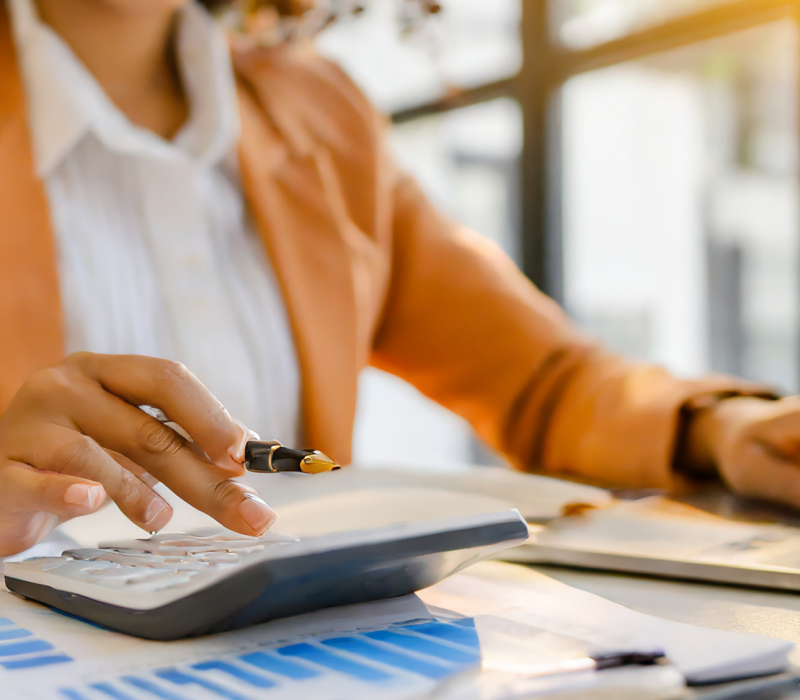 closeup-portrait-businesswoman-accountant-using-calculator-laptop-matching-financial-data